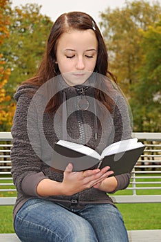 Young woman reading book