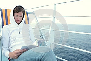 Young woman reading a book on a liner