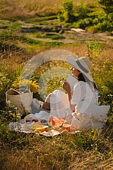 Young woman reading book in outdoor field. Reading and relaxation