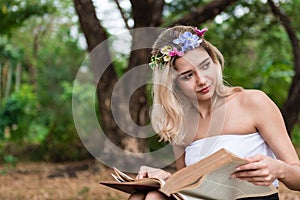 Young woman reading a book in the park