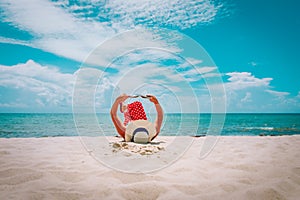 Young woman reading book on tropical beach vacation