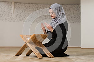 Young Woman Reading The Koran At The Mosque