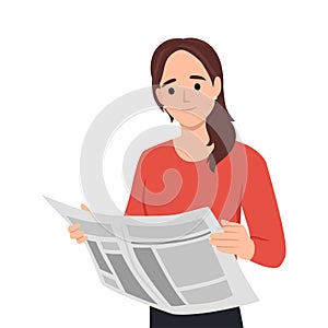 Young woman reading newspaper