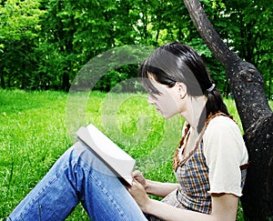 Young woman reading a novel photo