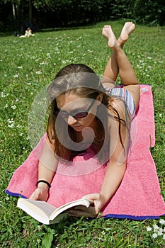Young woman reading in park photo