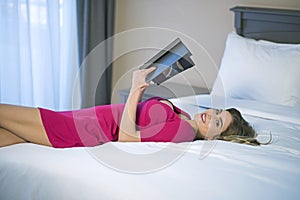 Young woman reading relaxing while reading in bed.