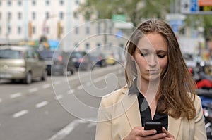 Young woman reading a text message on her mobile