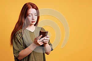 young woman reading text message on smartphone or mobile cell phone