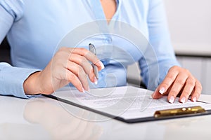 Young woman reads a signed contract