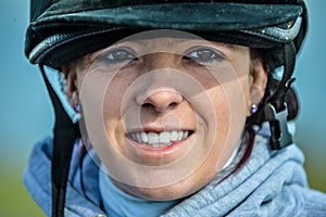 Young woman ready to go and ride her horse.