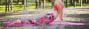 Young woman ready to practicing yoga in a forest. Upward Facing Dog Pose. Calmness, relax, mind.