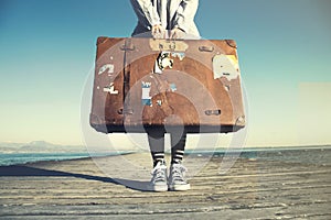 Young woman ready to travel with her suitcase