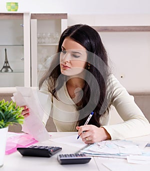 The young woman with receipts in budget planning concept