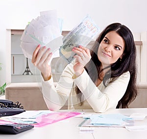 Young woman with receipts in budget planning concept