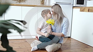 A young woman receives yellow daffodils as a gift from her husband or partner, smiling at him.vertical