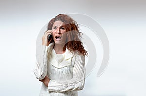 Young woman receiving bad news on her mobile
