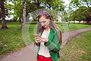 Young woman receiving a disturbing message on her phone