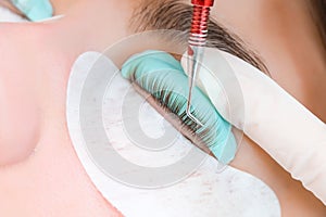 Young woman receiving eyelash lamination procedure in a beauty salon