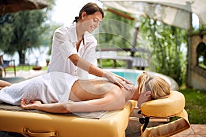 Young woman receiving full body massage at the spa salon profess