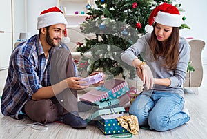 Young woman receiving gold watch as christmas gift