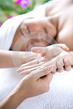 Young woman receiving hand massage