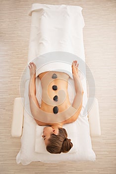 Young woman receiving hot stone massage