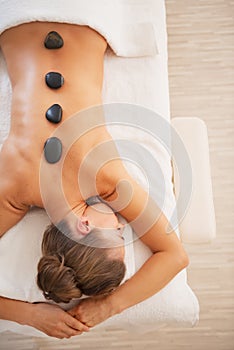 Young woman receiving hot stone massage