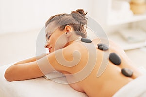 Young woman receiving hot stone massage