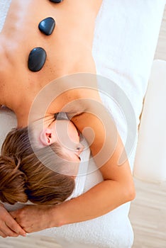 Young woman receiving hot stone massage