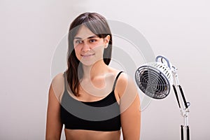 Young Woman Receiving Infrared Radiation Heat Light Lamp Therapy