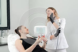 Young woman receiving laser treatment in cosmetology clinic