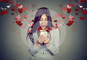 Young woman receiving love sms text message on mobile phone