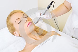 Young woman receiving microdermabrasion treatment