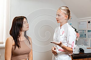 A young woman at a reception with a professional cosmetologist in a beauty salon. The concept of cosmetology and