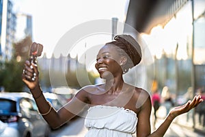 Young woman recording a video with a camera in a city