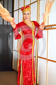 Young woman in red Andalusian costume dances with