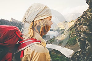 Young Woman with red backpack hiking alone Travel Lifestyle concept