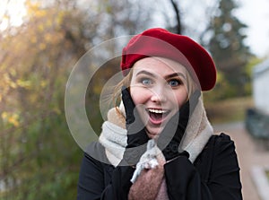 Young woman with red beret have a joyful suprised expression