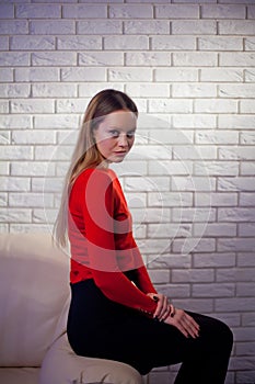 Young woman in red blouse next to brick wall Stylish fashion mod
