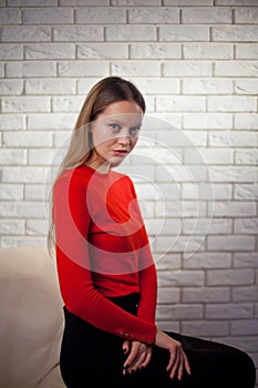 Young woman in red blouse next to brick wall Stylish fashion mod