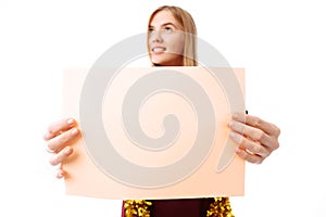 Young woman in red dress with blank paper on white background. C