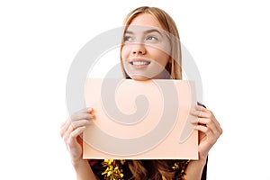 Young woman in red dress with blank paper on white background. C