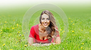 Young woman in red dress lying on grass