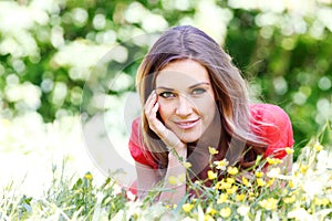 Young woman in red dress lying on grass