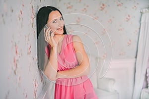 Young woman in red dress phone talking. Smartphone call. Girl smail and talk with mobile