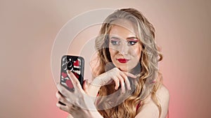 Young Woman in Red Dress Taking a Selfie