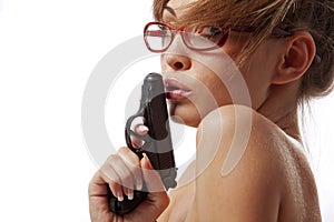 Young woman in red glasses with handgun