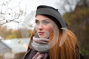 Young woman with red  hair and black beret