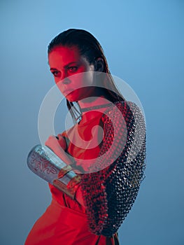 young woman red light silver armor chain mail fashion blue background