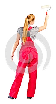 Young woman in red overalls with painting tools